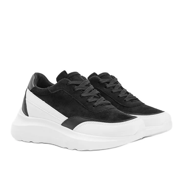 Black sneakers with white details on a Barteks high sole