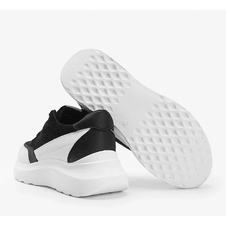 Black sneakers with white details on a Barteks high sole