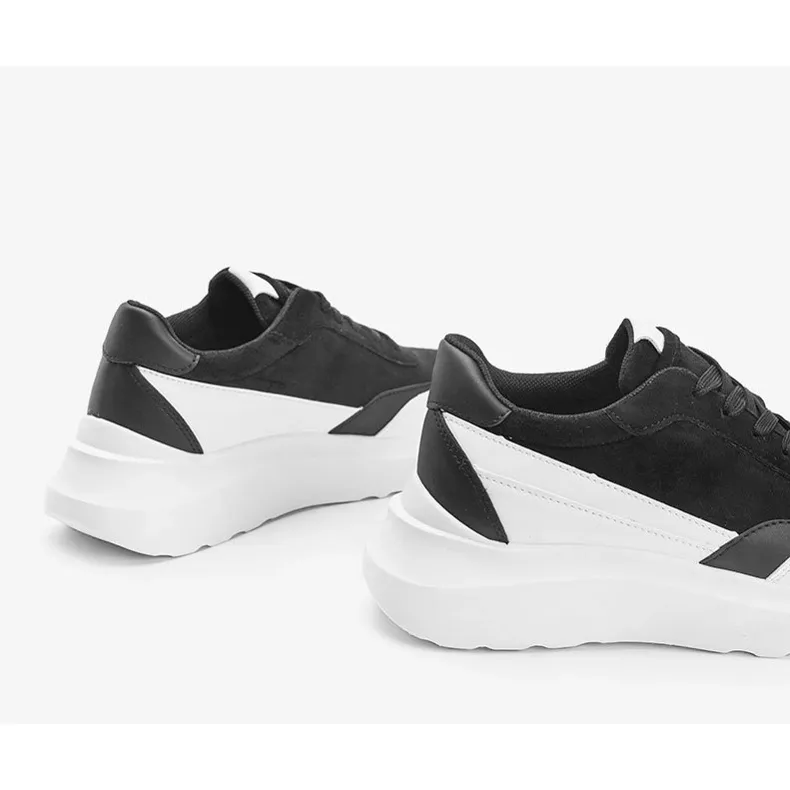 Black sneakers with white details on a Barteks high sole